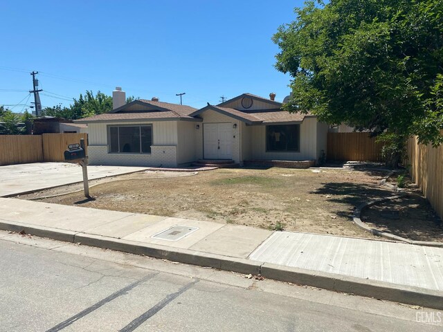351 Adams St, Wasco, CA 93280 - view of front of property featuring brick siding and a chimney
