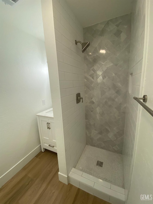 351 Adams St, Wasco, CA 93280 - bathroom with wood finished floors, a stall shower, baseboards, and vanity