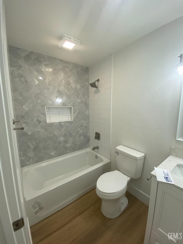351 Adams St, Wasco, CA 93280 - bathroom with wood finished floors, toilet, washtub / shower combination, and vanity