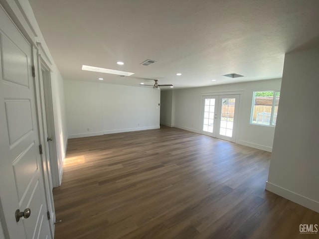 351 Adams St, Wasco, CA 93280 - empty room with baseboards, dark wood-type flooring, ceiling fan, recessed lighting, and a skylight