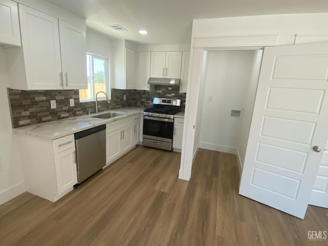 351 Adams St, Wasco, CA 93280 - kitchen with stainless steel appliances, a sink, white cabinets, tasteful backsplash, and light stone counters