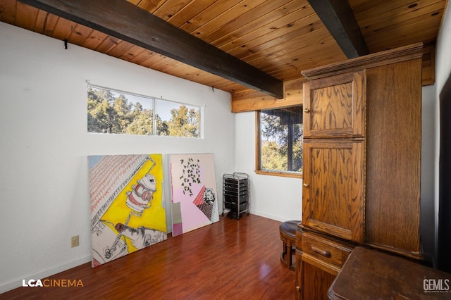 interior space with beam ceiling, wood ceiling, wood finished floors, and baseboards