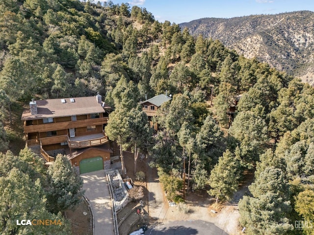 bird's eye view with a forest view and a mountain view