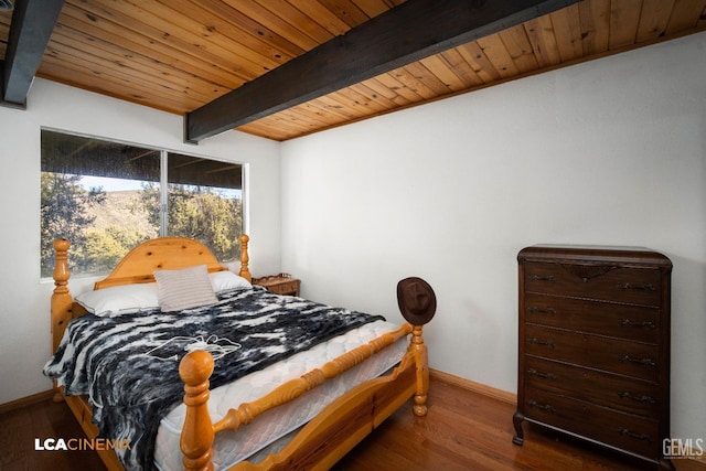 bedroom featuring beamed ceiling, baseboards, wood ceiling, and wood finished floors