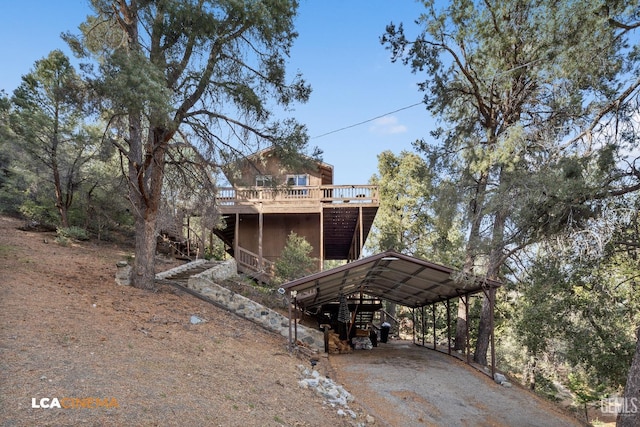 exterior space featuring a wooden deck and a carport