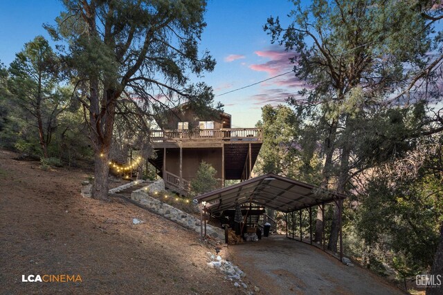 view of front of house with a carport and a deck