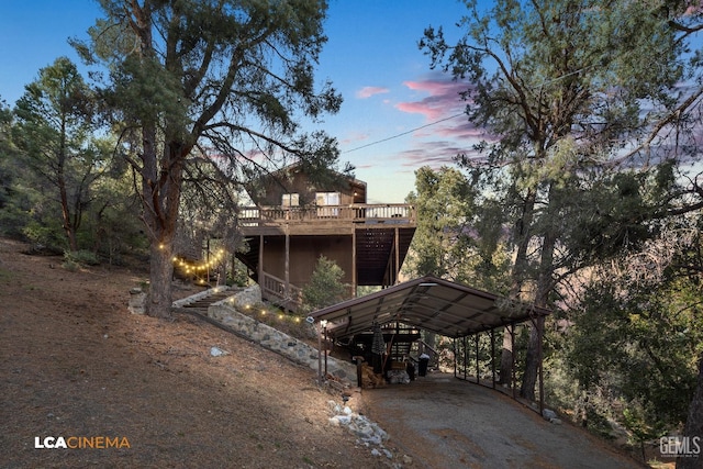 exterior space featuring a carport, driveway, and a wooden deck