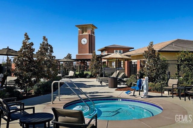 view of pool featuring a patio, fence, and a hot tub