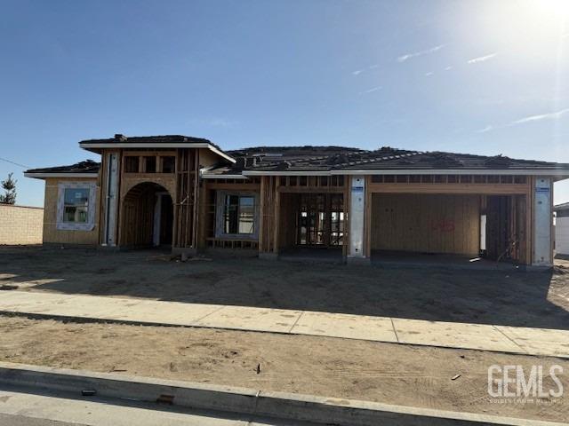 unfinished property with dirt driveway and a garage