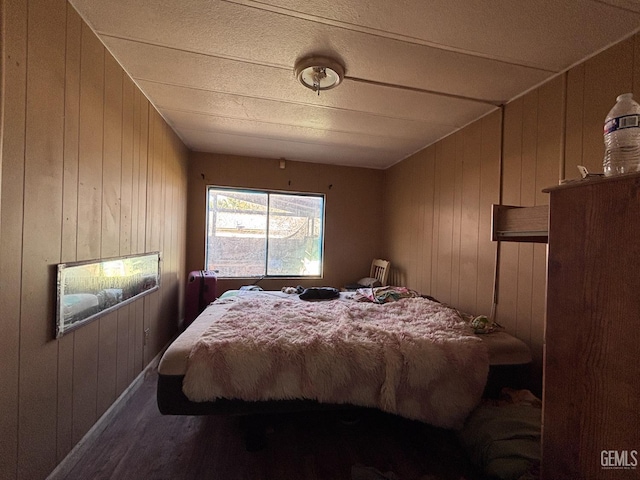 bedroom featuring wood walls