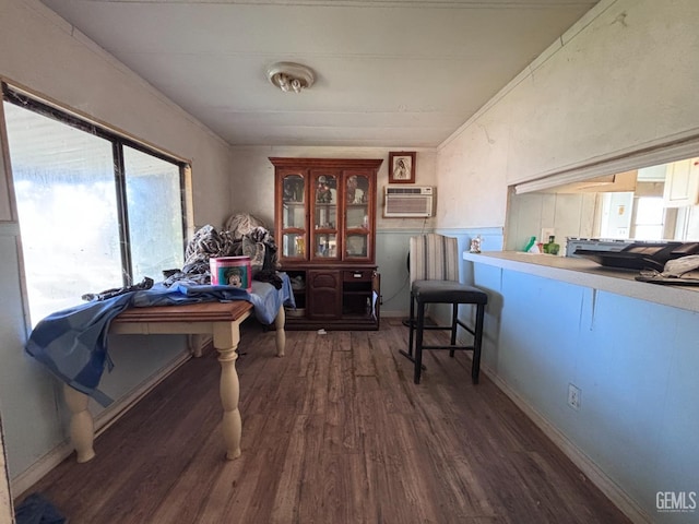 interior space with dark wood-type flooring and a wall unit AC