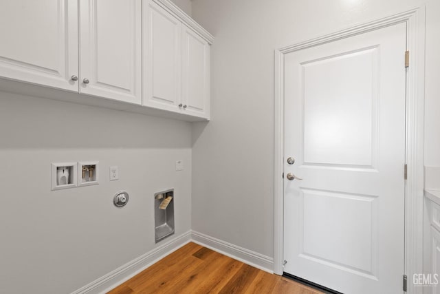 washroom featuring light wood-type flooring, cabinets, washer hookup, and gas dryer hookup