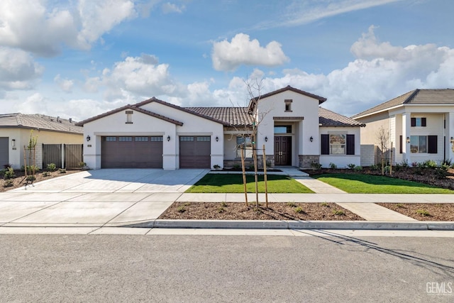 mediterranean / spanish home with a garage and a front yard