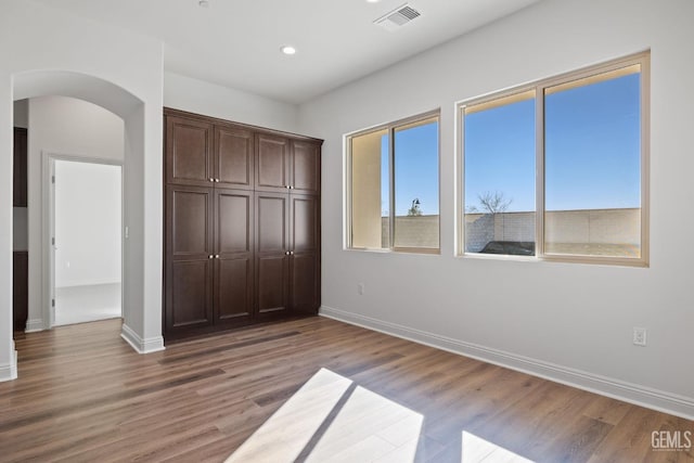 unfurnished bedroom featuring light wood-type flooring and a closet