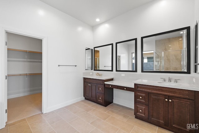 bathroom with tile patterned flooring, walk in shower, and vanity