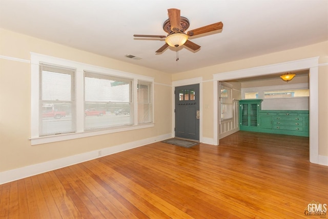 empty room with ceiling fan and wood-type flooring