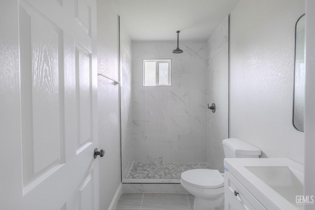 bathroom with vanity, a shower stall, and toilet