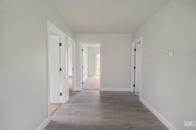 hall with light wood finished floors and baseboards