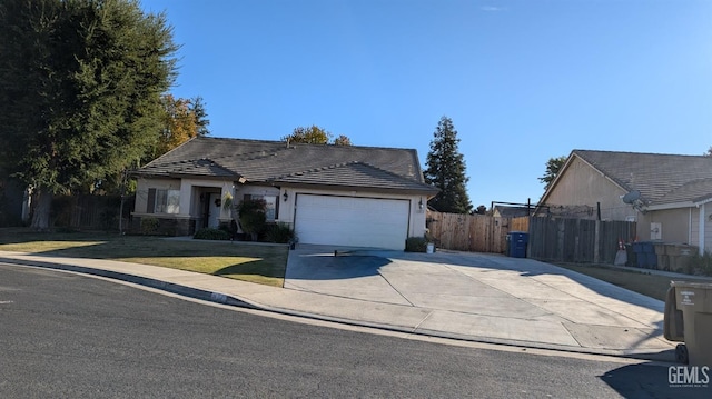 single story home featuring a garage and a front lawn