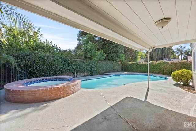 7601 Live Oak Way, Bakersfield, CA 93308 - view of pool with a fenced backyard, a patio area, and a pool with connected hot tub