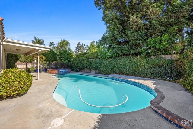 7601 Live Oak Way, Bakersfield, CA 93308 - view of swimming pool with a fenced backyard, a pool with connected hot tub, and a patio area