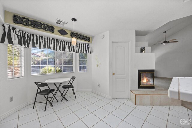 7601 Live Oak Way, Bakersfield, CA 93308 - dining room with a tile fireplace, baseboards, ceiling fan, and light tile patterned flooring