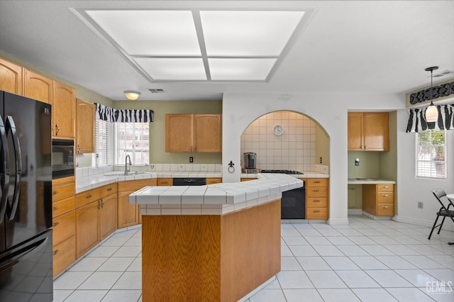 7601 Live Oak Way, Bakersfield, CA 93308 - kitchen featuring black appliances, a sink, tile countertops, light tile patterned flooring, and a kitchen island