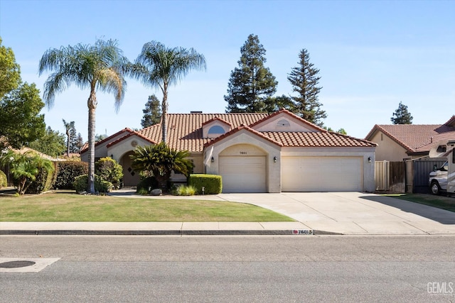 7601 Live Oak Way, Bakersfield, CA 93308 - mediterranean / spanish house with a garage, stucco siding, concrete driveway, and a tiled roof