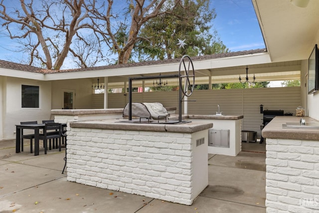 view of patio / terrace featuring an outdoor bar and an outdoor kitchen