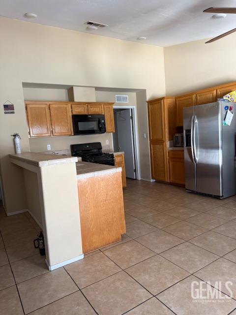 10011 Grand View Summit Dr, Bakersfield, CA 93311 - kitchen with black appliances, light tile patterned flooring, a ceiling fan, light countertops, and a towering ceiling
