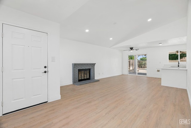 1317 Canyon Ct, Bakersfield, CA 93307 - unfurnished living room featuring lofted ceiling, light wood finished floors, ceiling fan, a fireplace, and recessed lighting