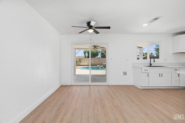 1317 Canyon Ct, Bakersfield, CA 93307 - unfurnished living room with a sink, light wood-style floors, baseboards, a ceiling fan, and recessed lighting