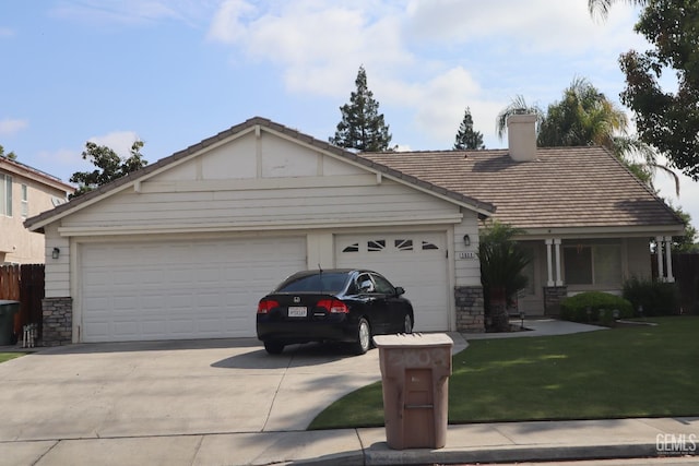 ranch-style home featuring a chimney, stone siding, a front lawn, concrete driveway, and an attached garage