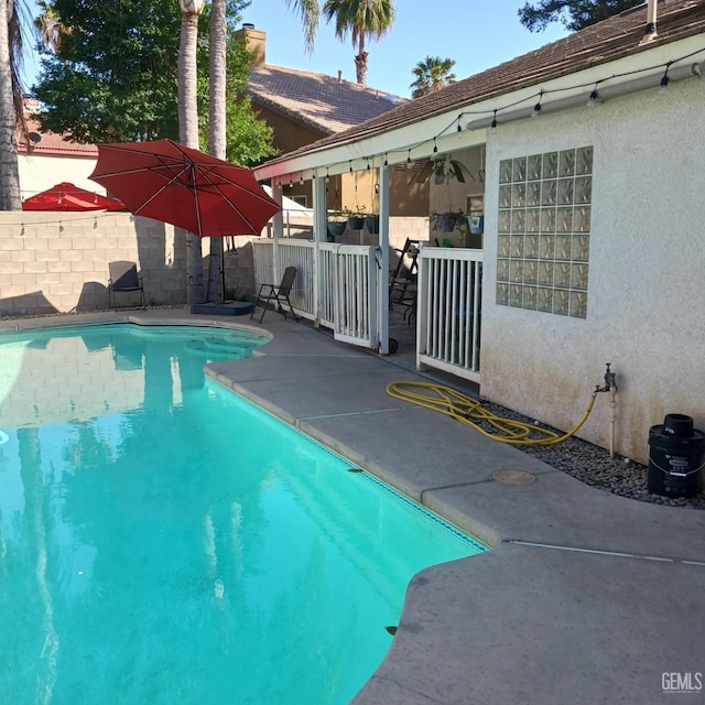 view of pool with fence, a fenced in pool, and a patio area