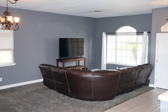 living area featuring visible vents, baseboards, an inviting chandelier, tile patterned floors, and a textured ceiling