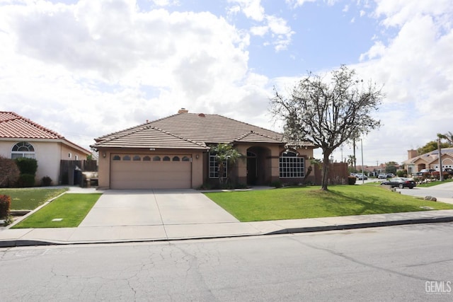 view of front of home featuring a front lawn, concrete driveway, a tile roof, stucco siding, and a garage