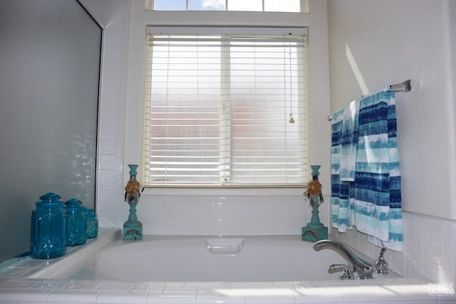 bathroom featuring a wealth of natural light and a garden tub