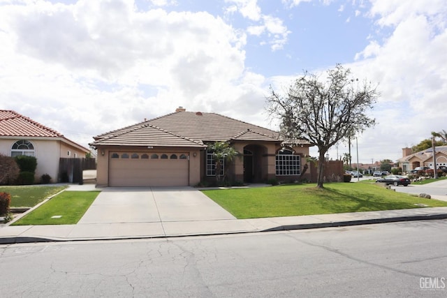 view of front facade featuring stucco siding, concrete driveway, a front yard, a garage, and a tiled roof