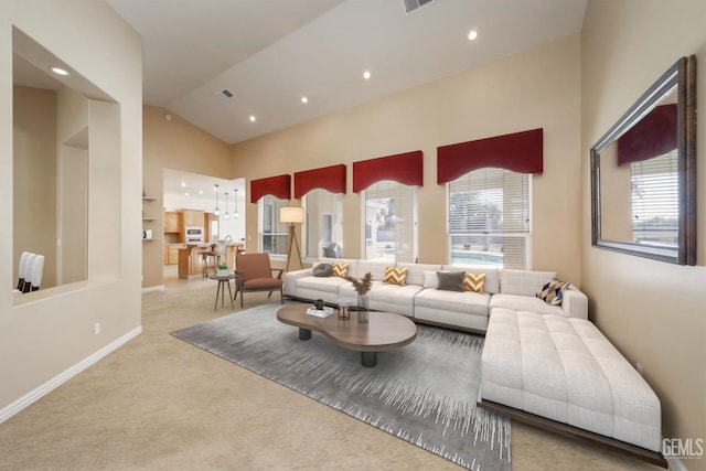 carpeted living room featuring lofted ceiling