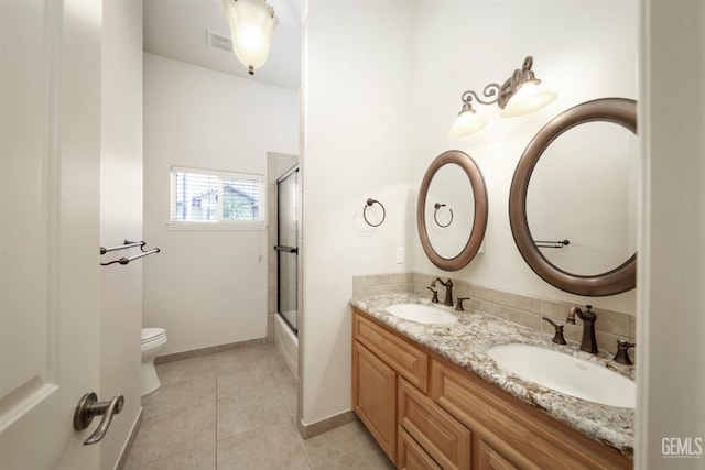 full bathroom with tile patterned floors, vanity, toilet, and enclosed tub / shower combo