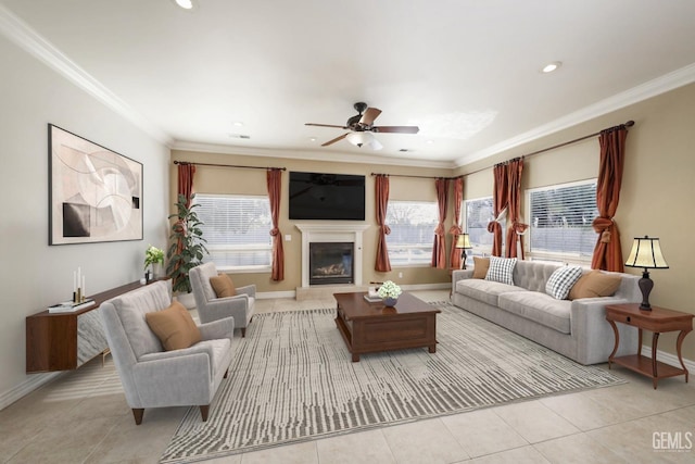 tiled living room with ceiling fan and crown molding