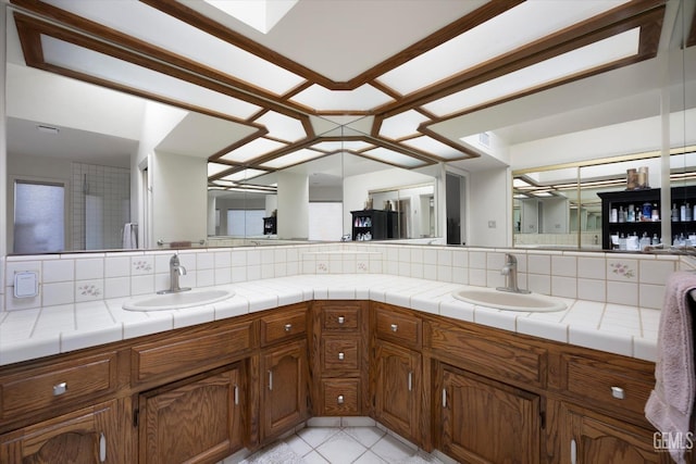 bathroom with tile patterned floors, backsplash, and vanity