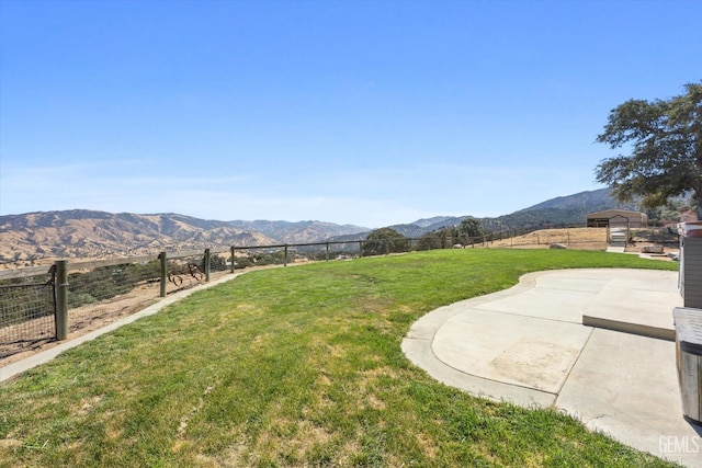 exterior space featuring a patio area, a mountain view, and a rural view