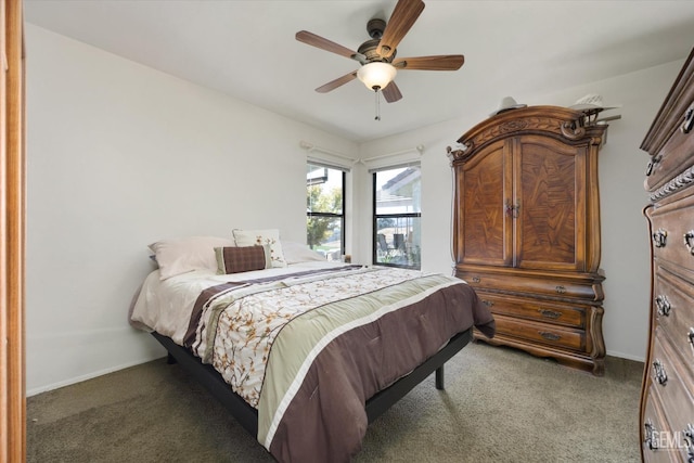 bedroom with ceiling fan and dark colored carpet