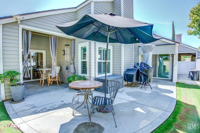 rear view of house featuring a chimney and a patio area