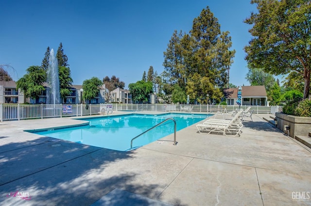 pool with fence and a patio area