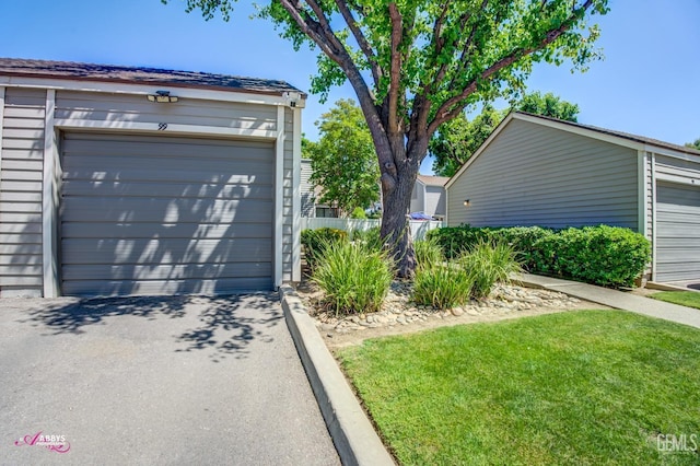 detached garage featuring fence
