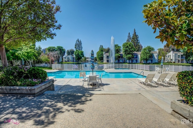 pool with fence, a residential view, and a patio