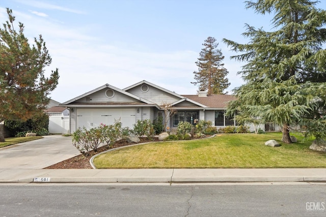 501 Reed St, Bakersfield, CA 93314 - single story home with driveway, a garage, a front yard, and a chimney