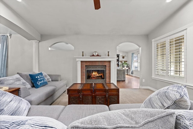 501 Reed St, Bakersfield, CA 93314 - carpeted living room with arched walkways, a brick fireplace, a ceiling fan, recessed lighting, and baseboards